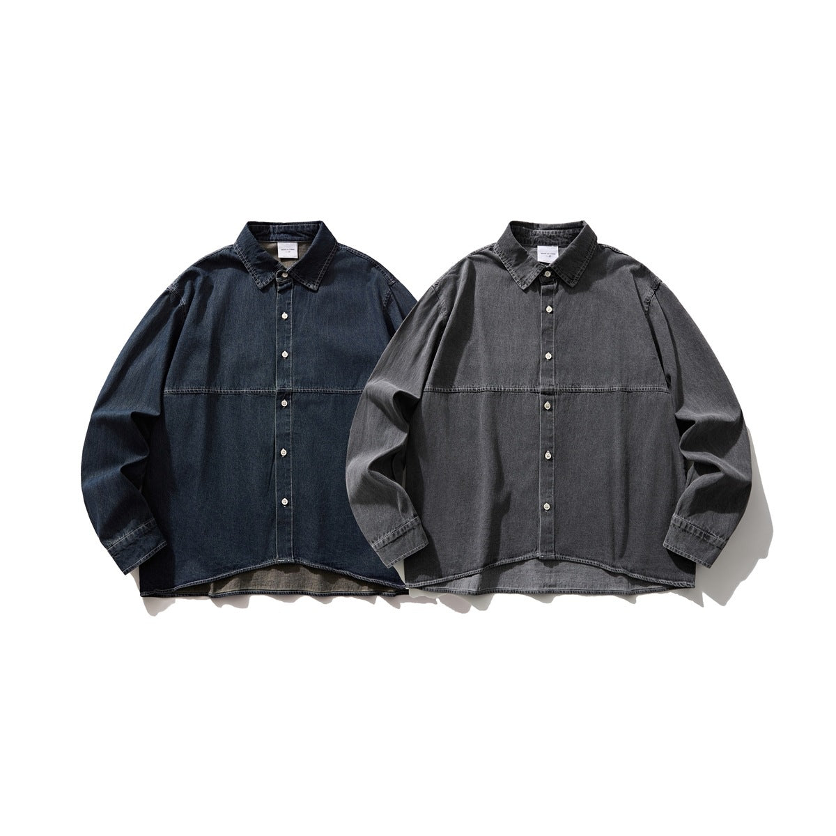 Two long-sleeved denim button-up shirts shown from the front: one dark blue and one charcoal gray.