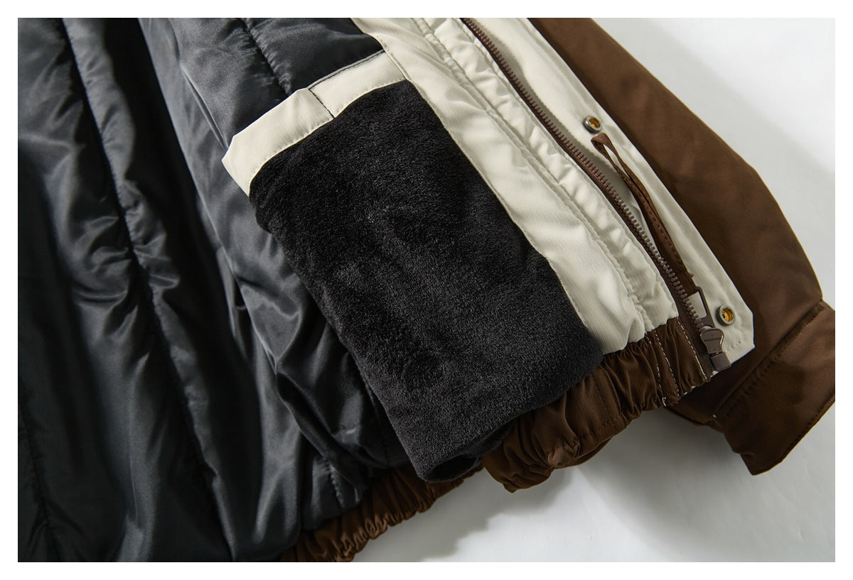 Close-up of the open jacket's plush black interior pocket, cream facing, brown zipper, and gathered hem.