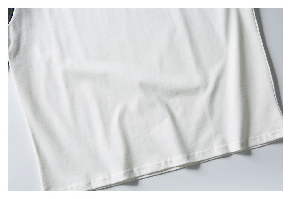 Close-up of the plain white T-shirt body and stitched bottom hem.