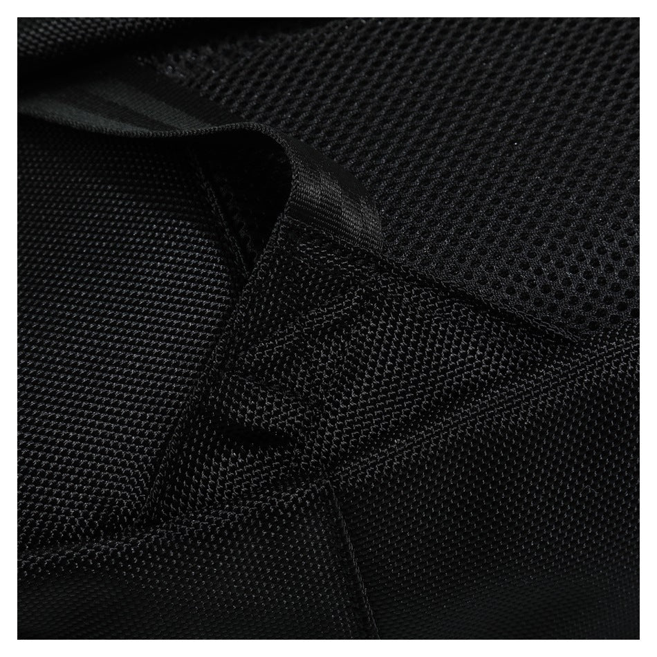 Close-up of black textured bag fabric, stitched seams, and a webbing loop.