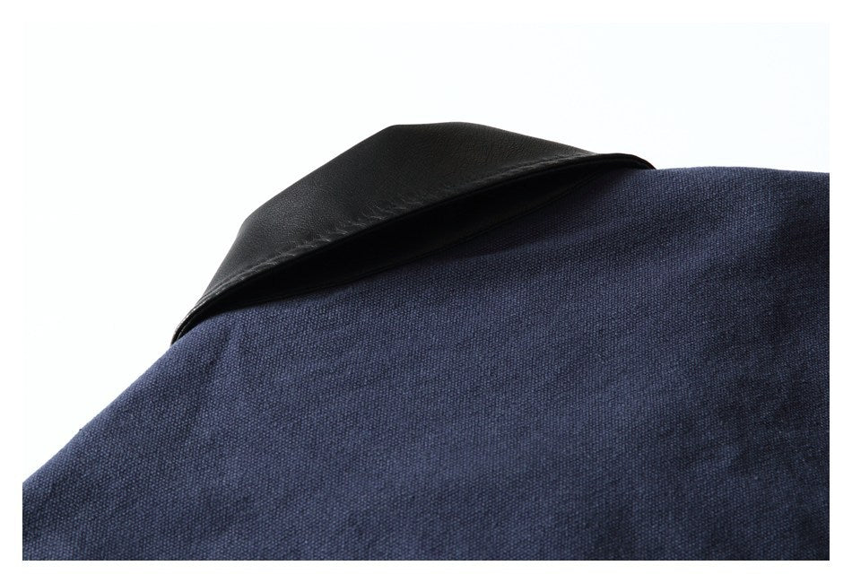 Close-up of a black collar against dark navy fabric.