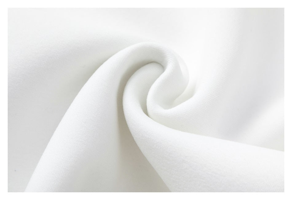Close-up of smooth white garment fabric gathered into a soft spiral fold.