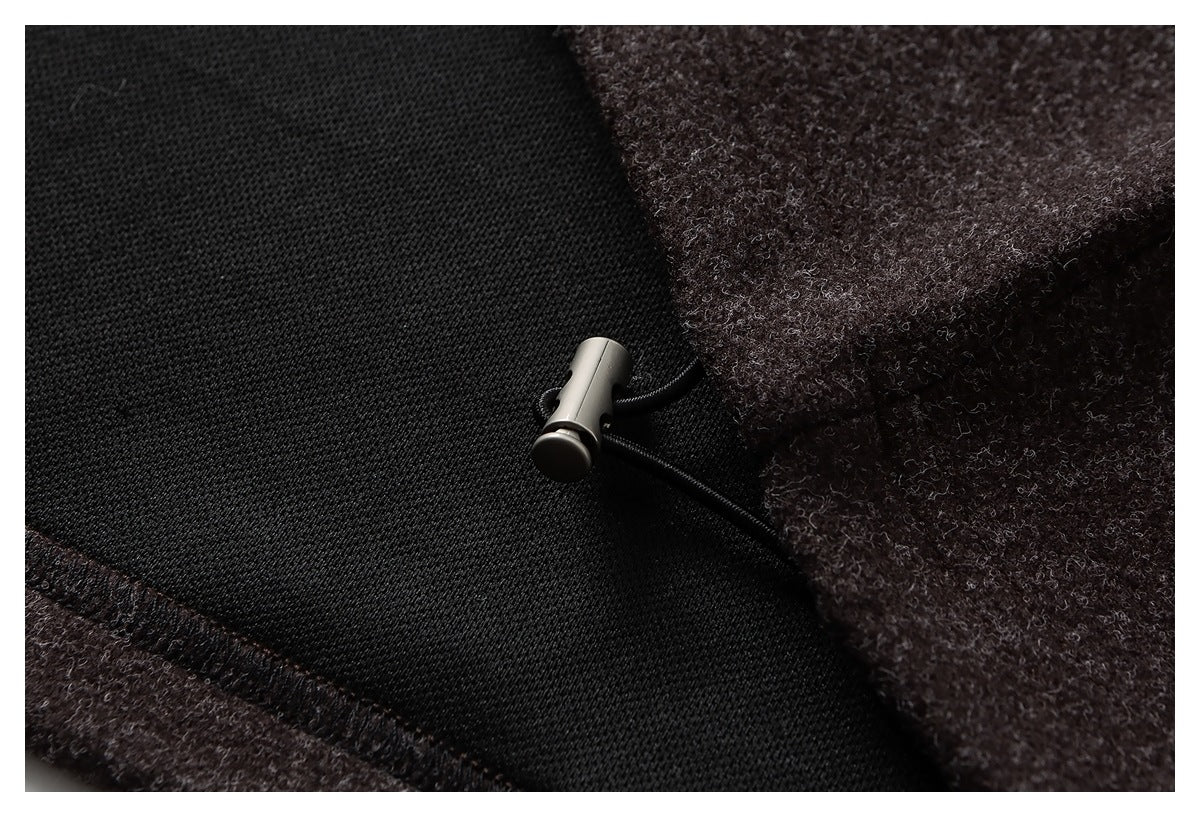 Close-up of the jacket's black lining and a small metal toggle closure.