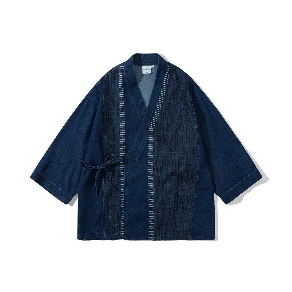 Blue denim kimono-style wrap jacket with side tie, white ladder stitching and three-quarter sleeves, flat front view