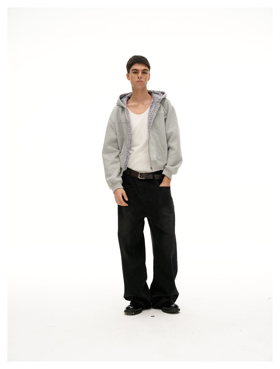 Model wearing a cropped gray zip hoodie with plaid hood lining, white tank, belt and wide black jeans