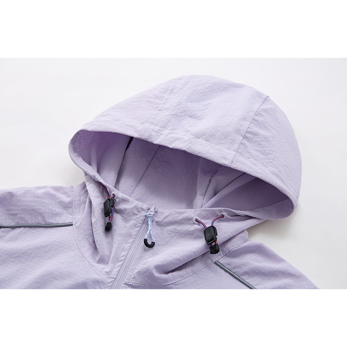 Close-up of a pale lavender jacket hood with adjustable drawcords, toggles and a front zipper.