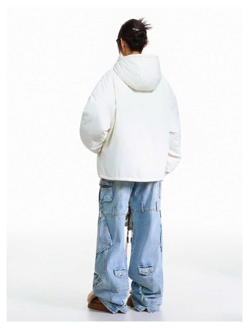 Back view of a model wearing an off-white hooded jacket with a large hood and loose blue cargo jeans.