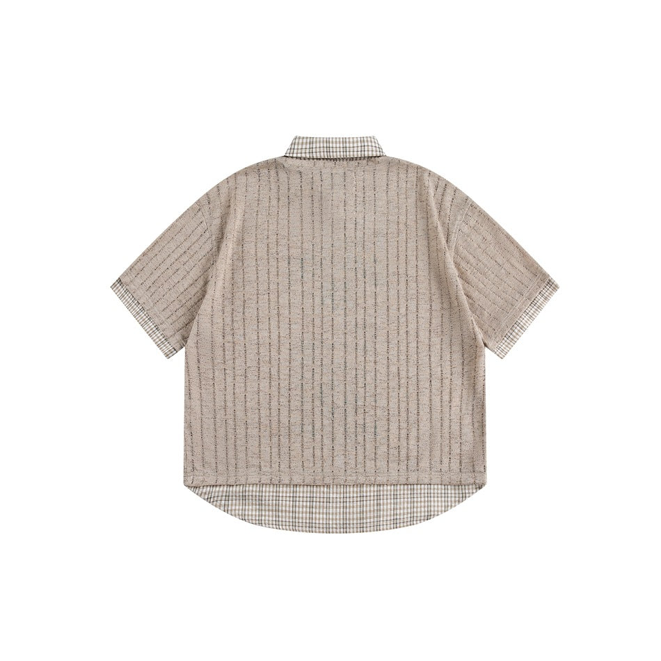 Back view of a beige short-sleeve shirt with subtle vertical texture and checked collar, cuffs, and longer hem.