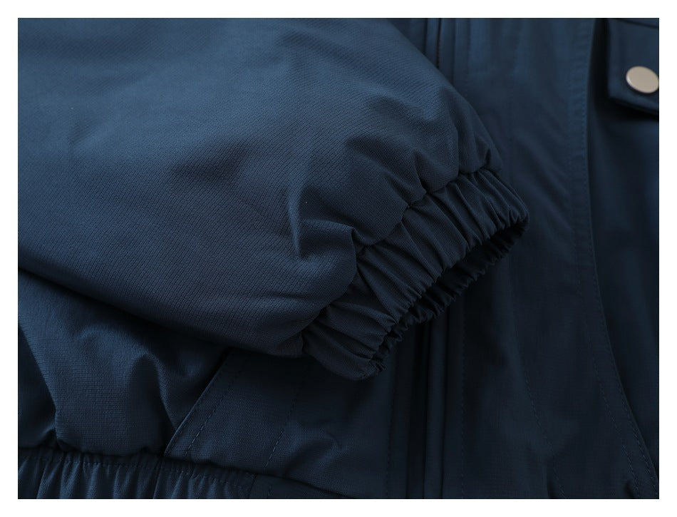 Close-up of a navy jacket sleeve with a gathered elastic cuff.