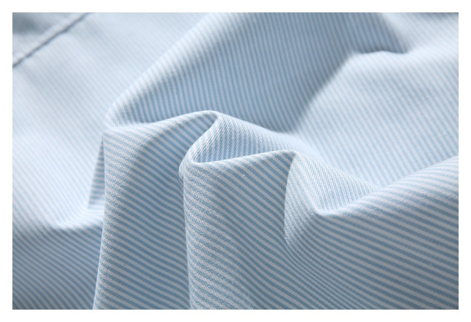 Close-up of folded pale blue and white fabric with fine diagonal stripes.