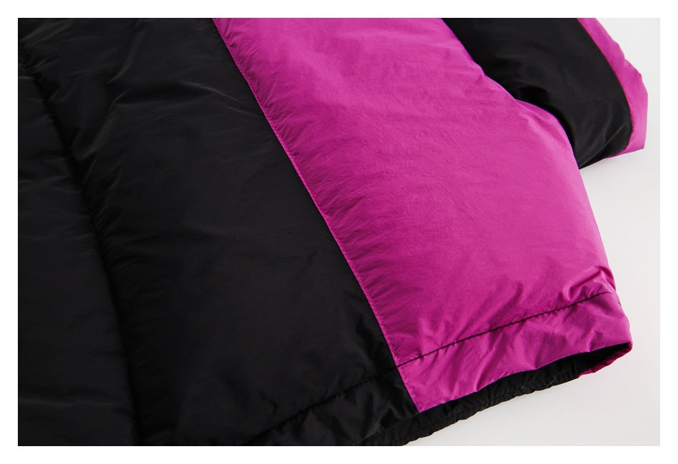 Close-up of a black padded garment with a wide magenta panel and hem seam.