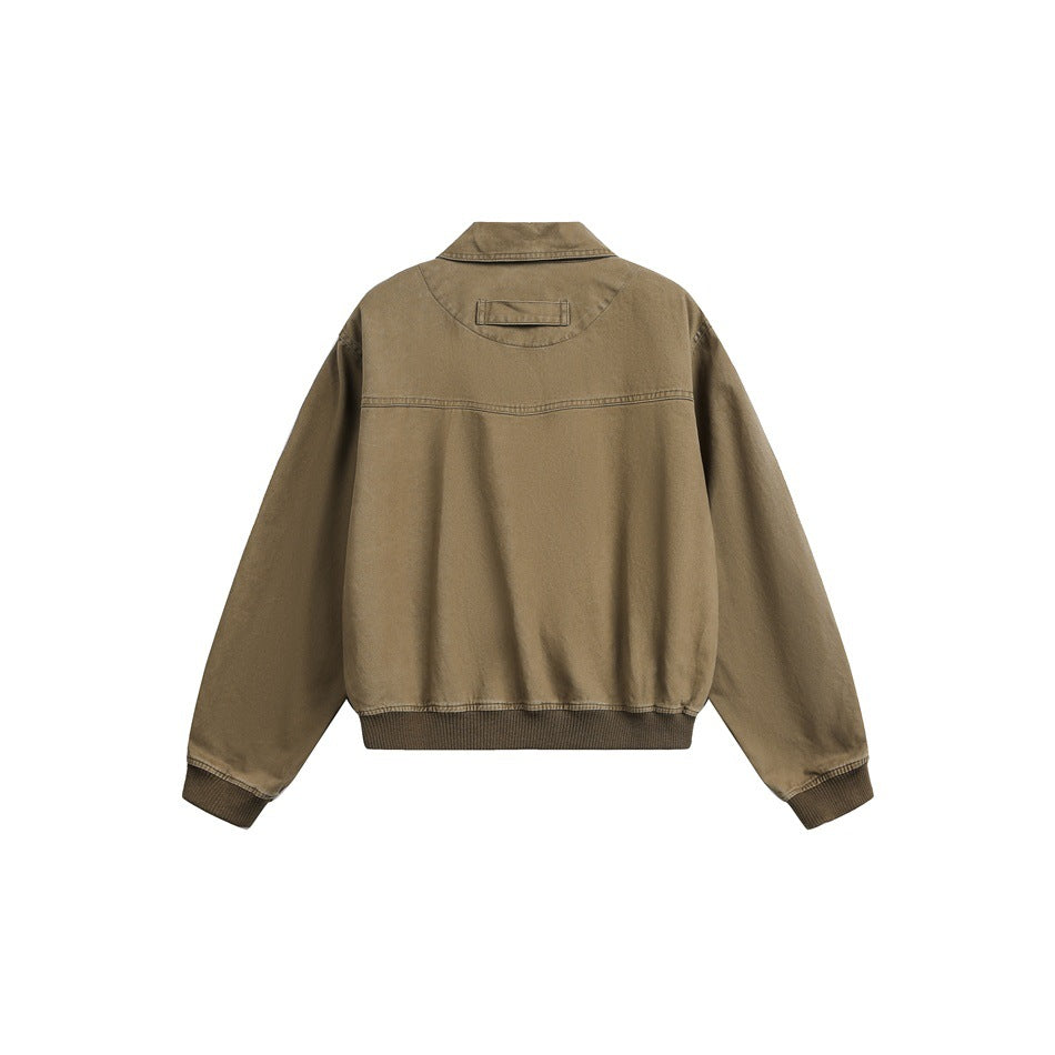 Back view of a brown cropped jacket with a pointed collar, long sleeves, ribbed cuffs and hem, and a back yoke.