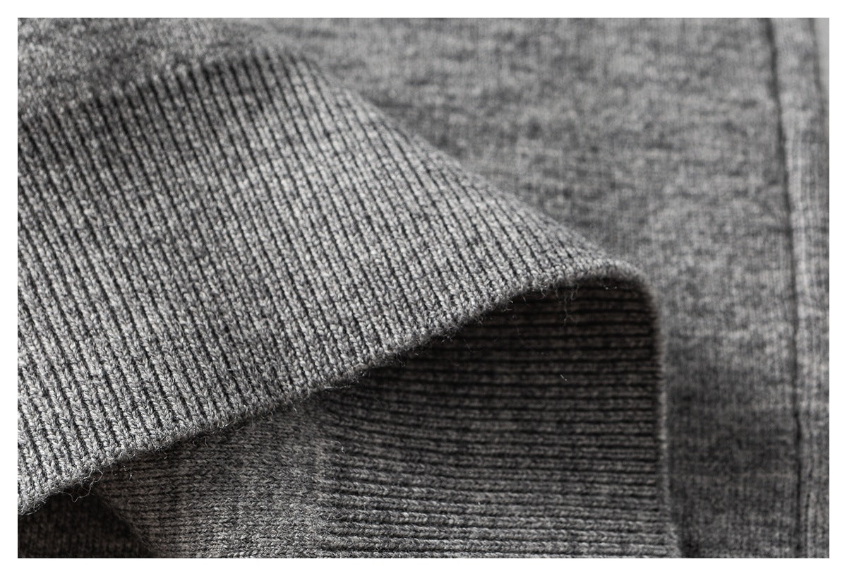 Close-up of a gray ribbed cuff folded over the matching knit garment.