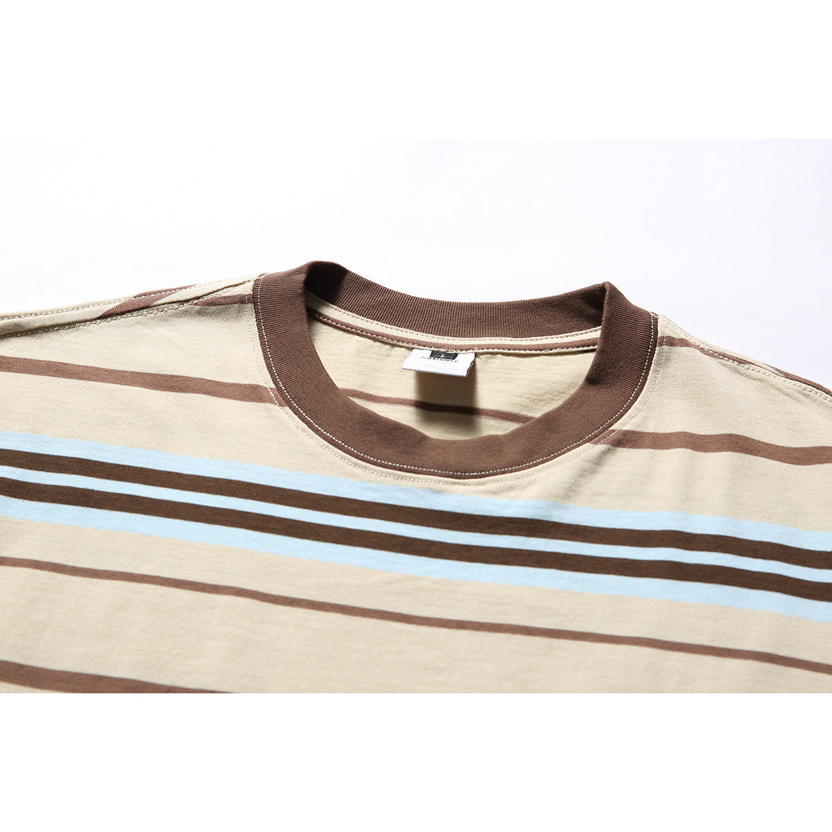 Close-up of a beige striped T-shirt with a dark brown ribbed crew neck and light blue and brown stripes.