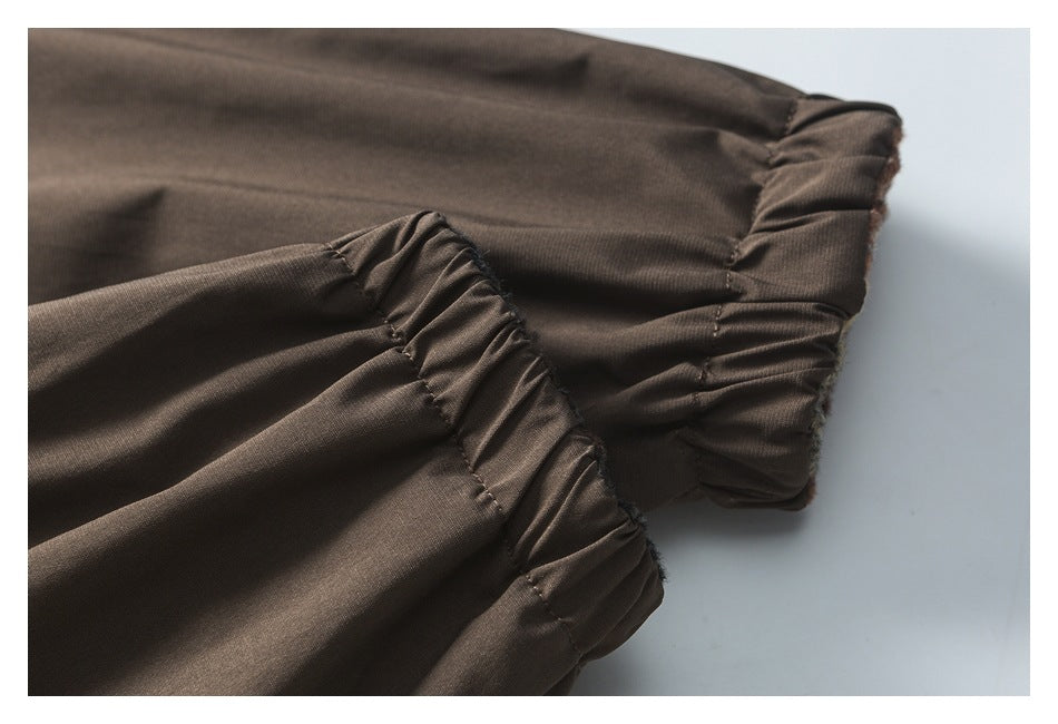 Close-up of the jacket's gathered elastic cuffs and brown fabric.