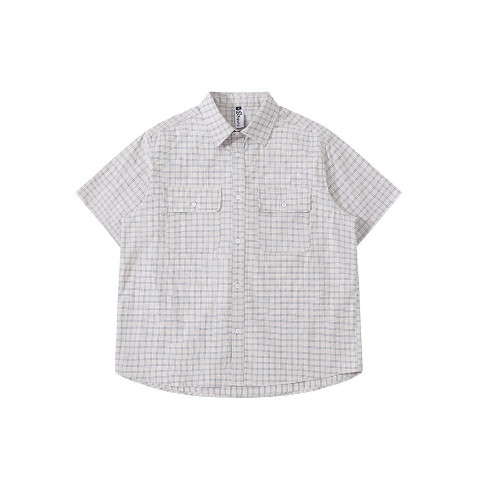 Grayish-white plaid short-sleeve button-up shirt with two chest flap pockets, laid flat, front view