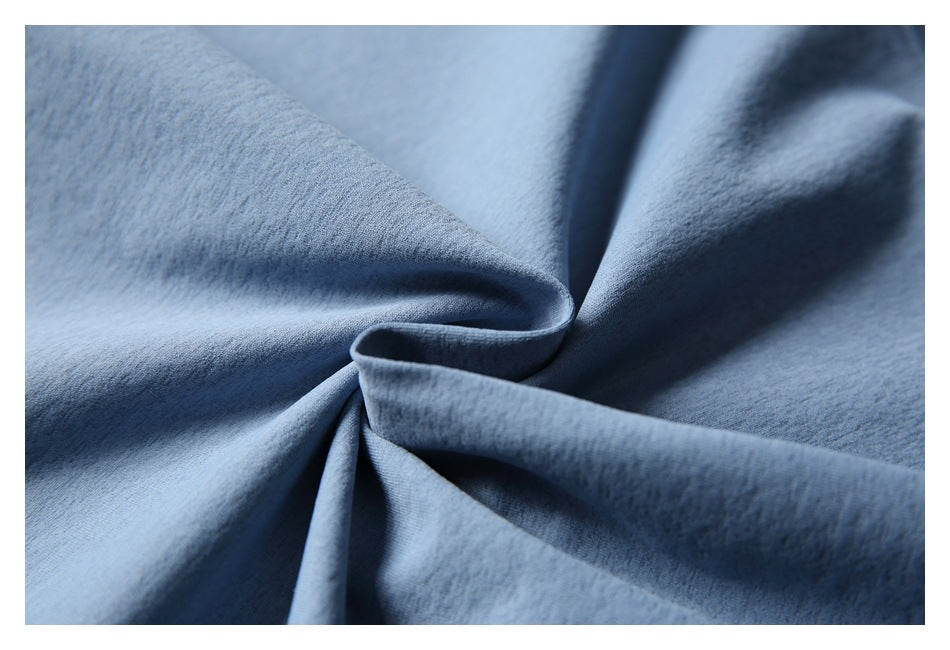 Close-up showing the soft-looking blue fabric gathered into folds.