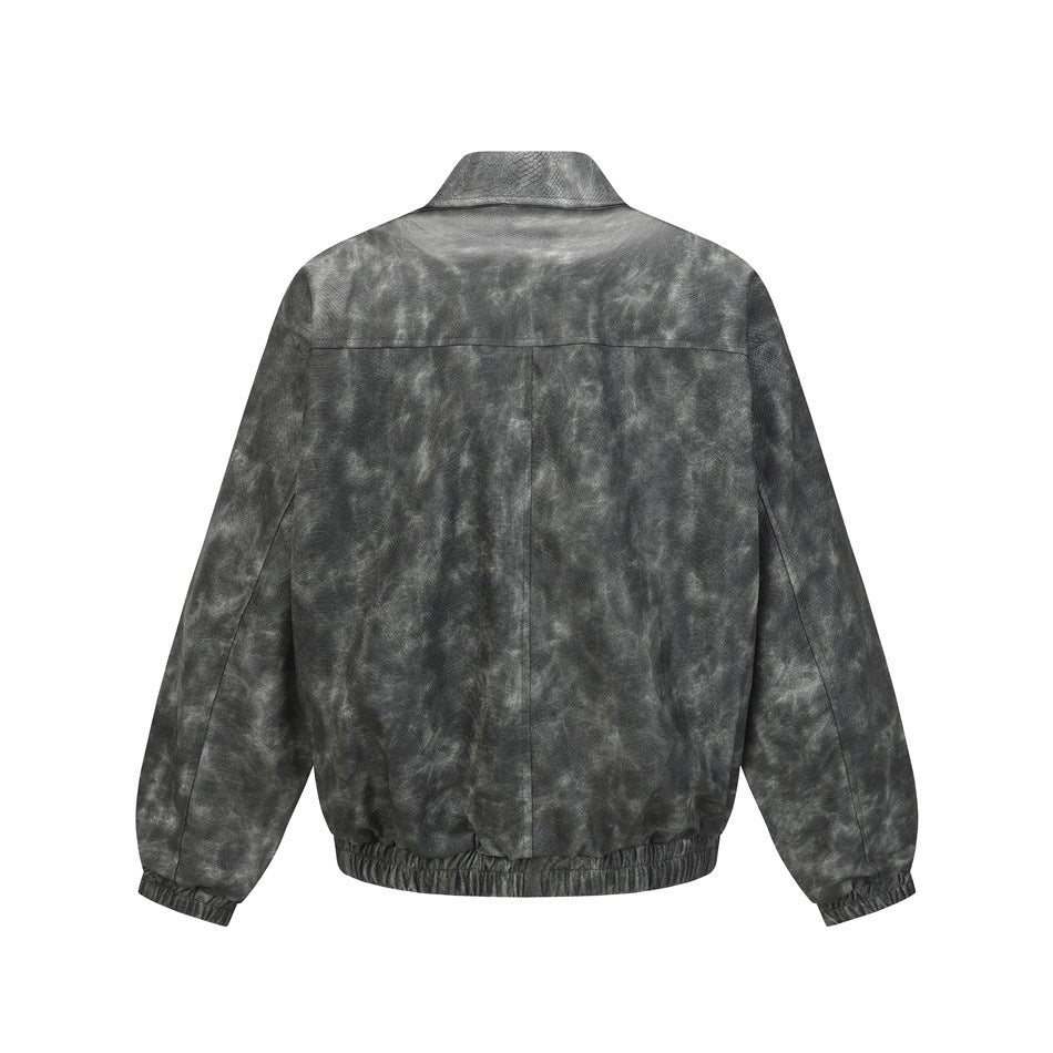 Back view of a charcoal gray mottled jacket with a raised collar, long sleeves, and gathered hem and cuffs.