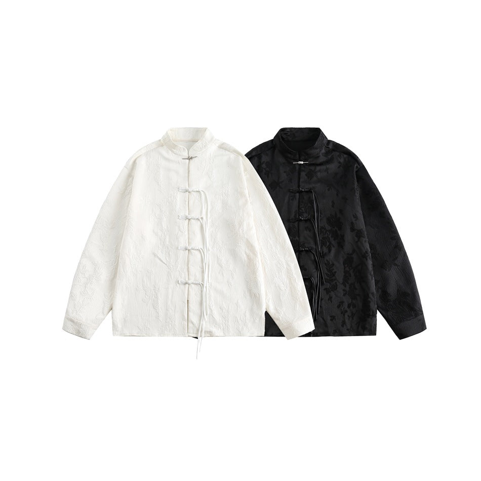 Two frog-button jackets shown flat against white: one white and one black with a subtle floral pattern.