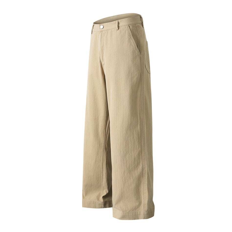Tan wide-leg trousers shown at an angle, with a button waistband, angled pockets and full-length hems.
