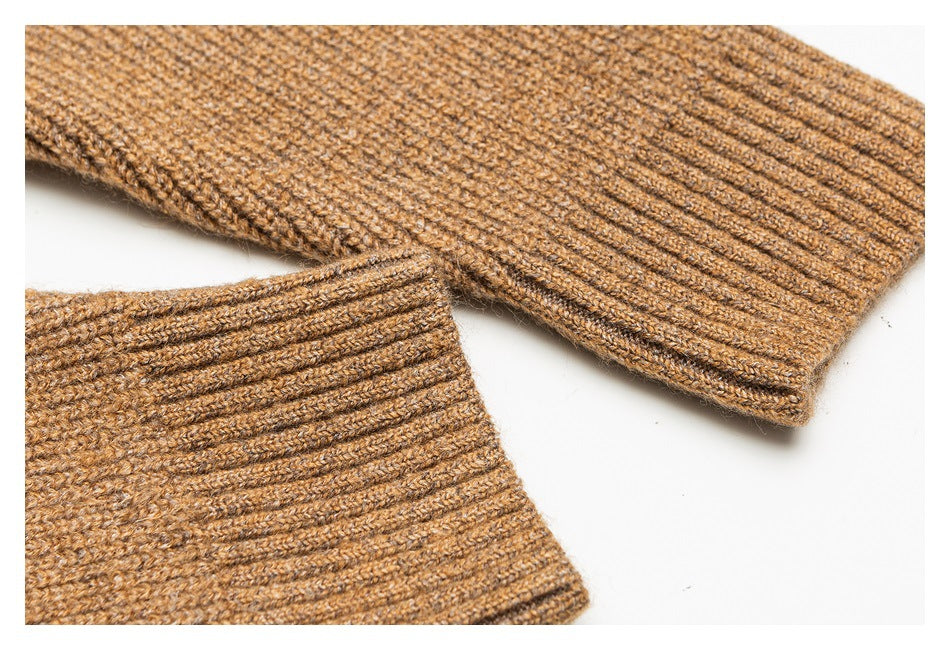 Close-up of the brown sweater's textured knit and ribbed cuff and hem edges.