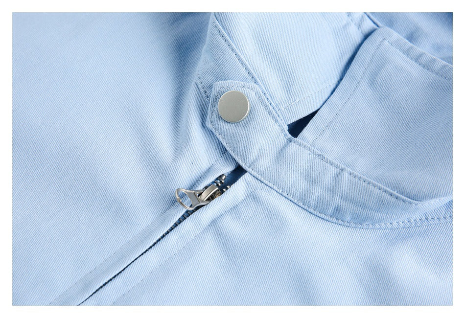 Close-up of the light blue jacket's snap fastening and zipper hardware.