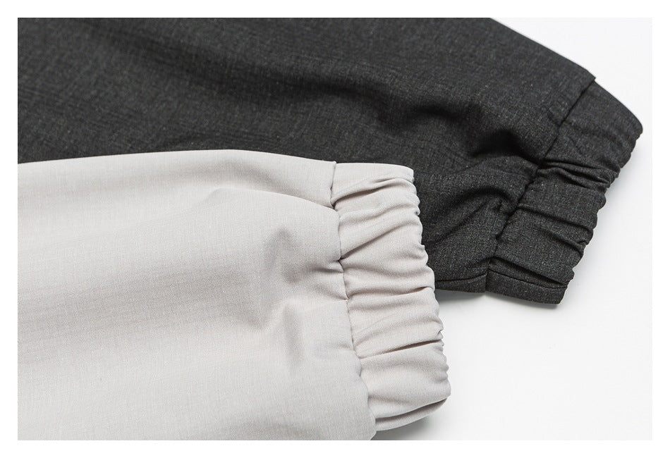 Close-up comparison of light gray and charcoal jacket sleeves showing gathered elastic cuffs.