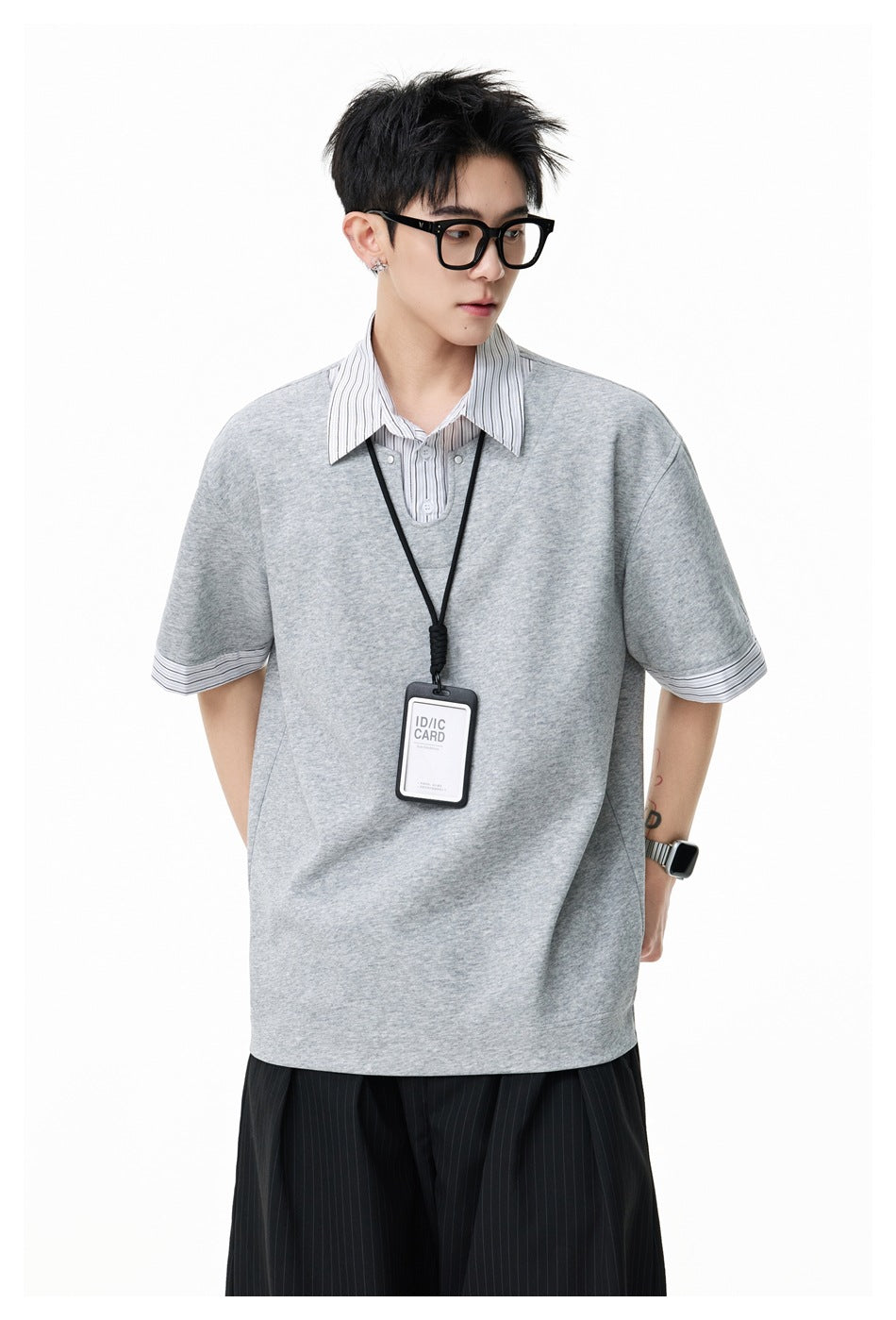 Close view of a model wearing a light gray oversized top with a white pinstriped collar and sleeve cuffs.