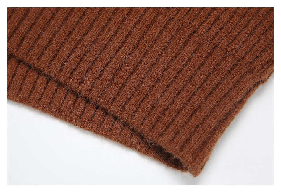 Close-up of the ribbed hem edge on a rust-brown cardigan.
