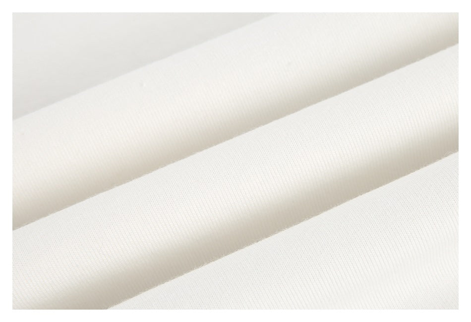 Close-up of white ribbed fabric folds showing the fine vertical knit texture.