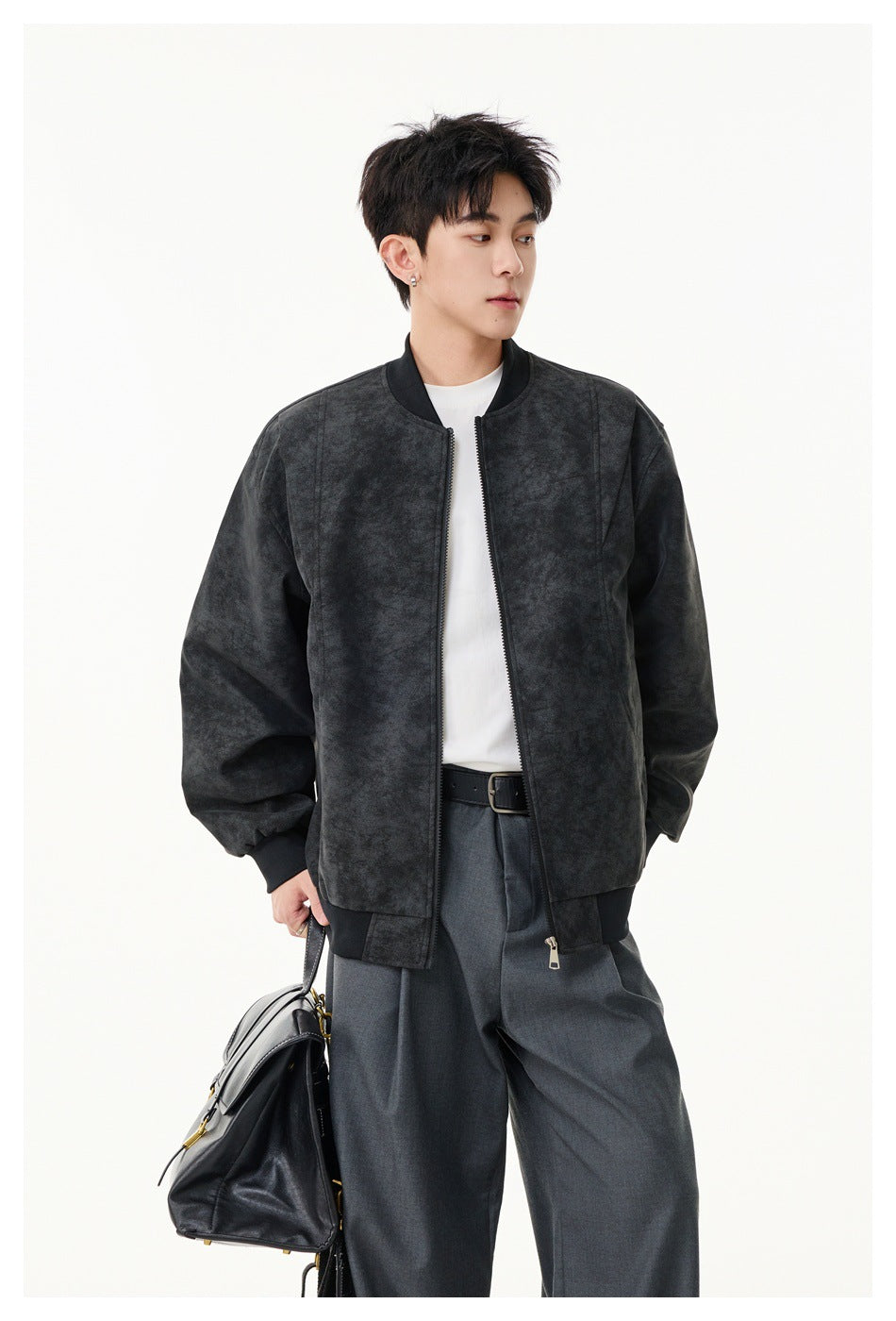 Model wearing an open dark charcoal mottled jacket with a zip front, ribbed trims and side pockets.