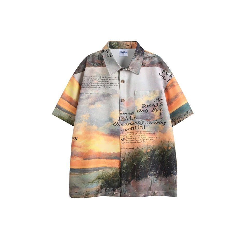 Orange sunset-print short-sleeve button-up shirt with beach grass scene, slogan text and chest pocket, flat view
