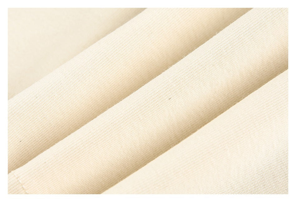 Macro view of cream fabric folds showing the knit texture.
