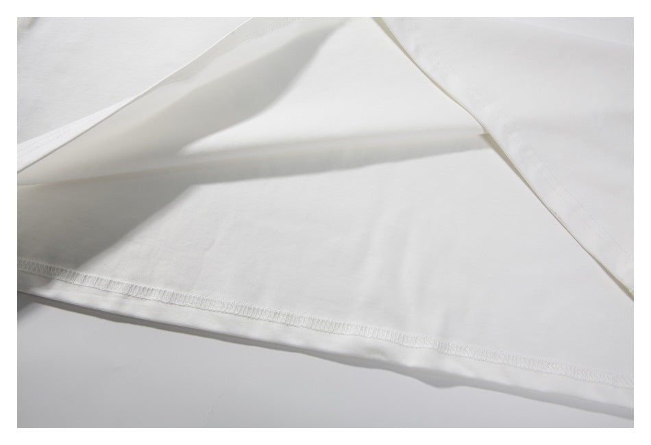 Close-up of the white T-shirt's lower hem and stitching.