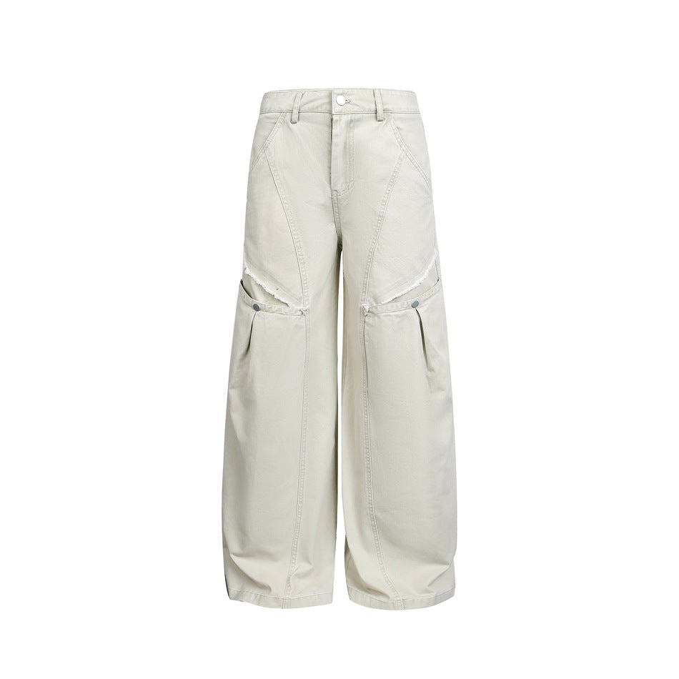 Washed light khaki wide-leg pants flat view with diagonal seams, frayed thigh slits and snap pockets