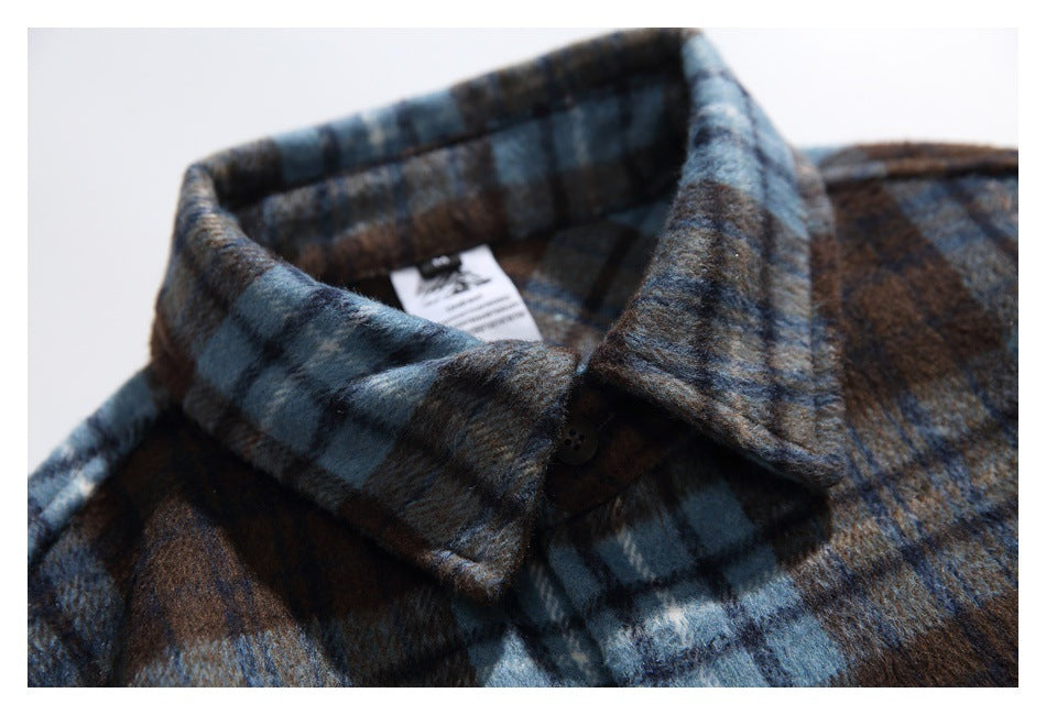 Close-up of the shirt's pointed plaid collar and top button, with an inside neck tag visible.