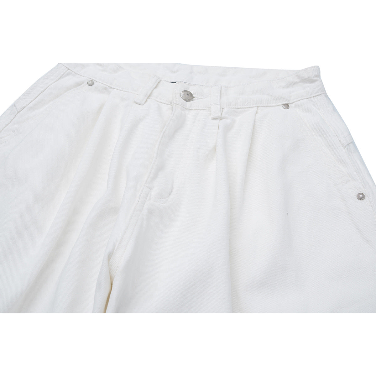 Close-up of white jeans showing the waistband, metal button, belt loops, and front pockets.