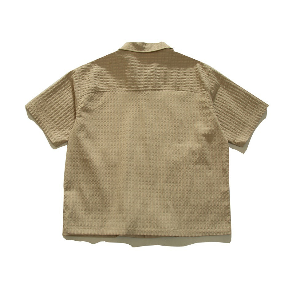 Back view of a taupe-brown short-sleeve collared shirt with a textured pattern.