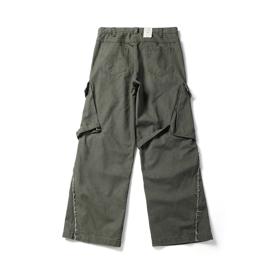 Back view of gray-green wide-leg cargo pants with two rear pockets, side cargo pockets and frayed outer seams.