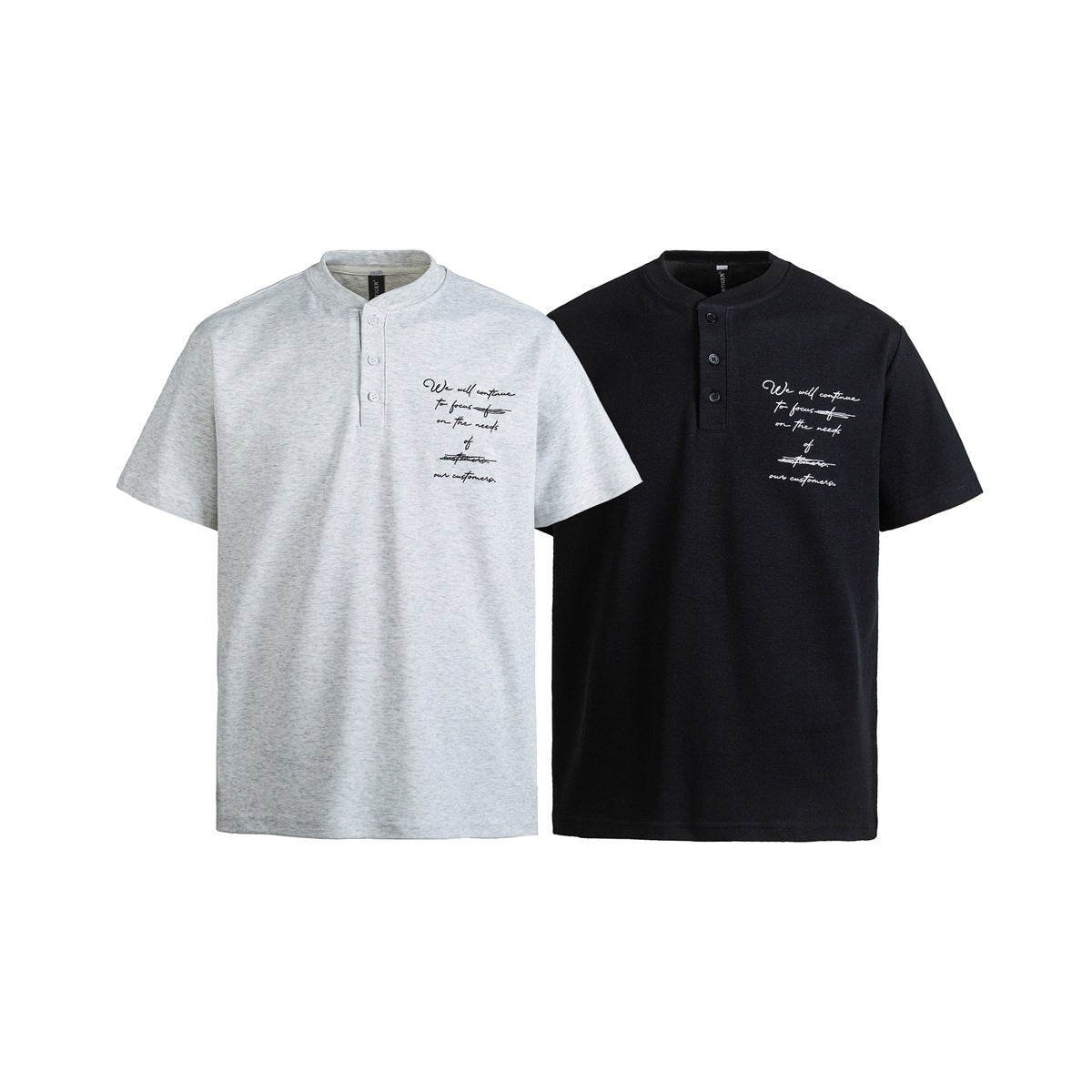 Front view of short-sleeve gray and black Henley shirts with button plackets and small cursive chest prints.