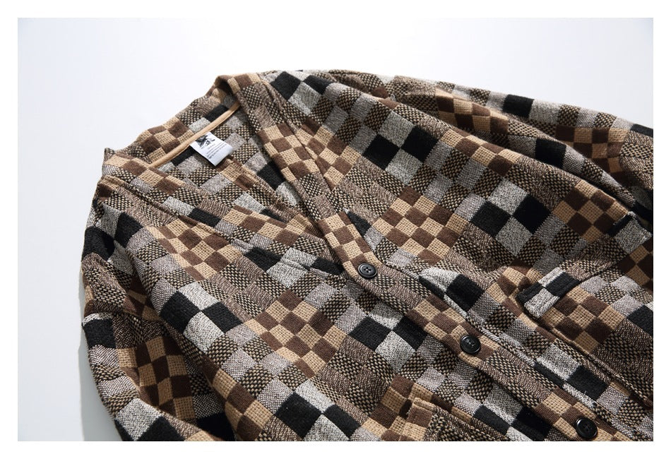 Flat lay of a brown, tan, gray, and black checkered button-front shirt, cropped around the shoulders and body.
