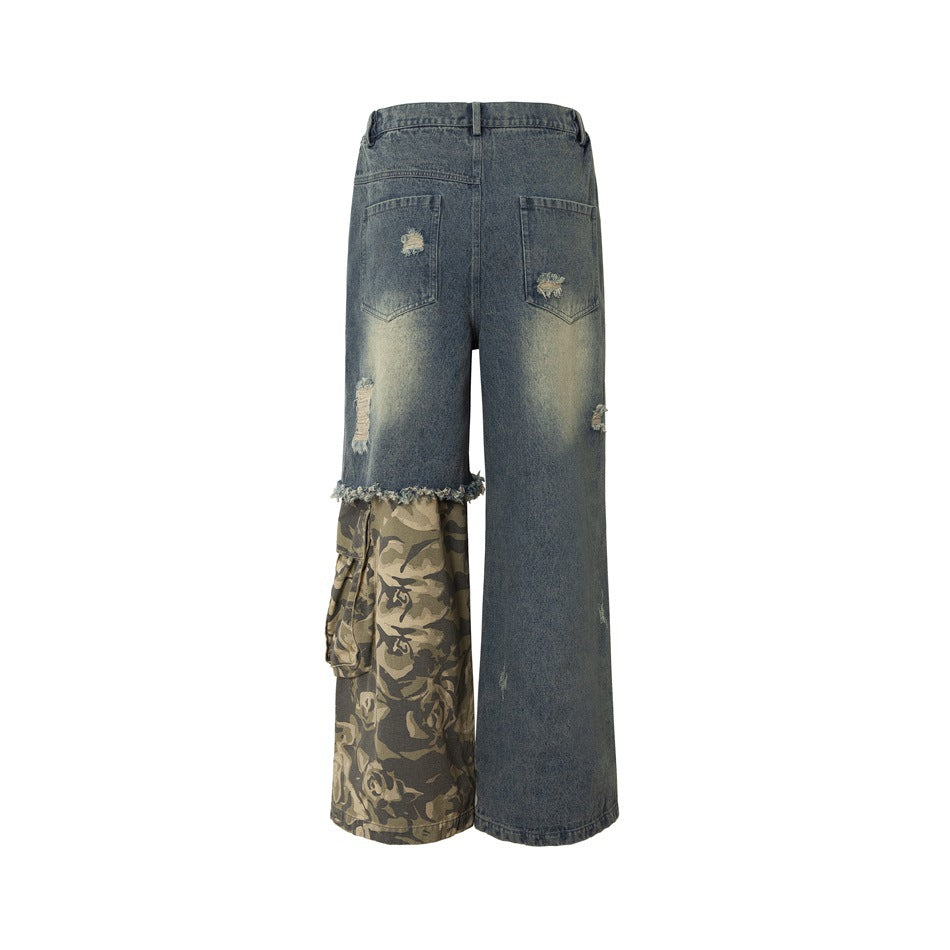Back view of wide-leg faded denim pants with distressed back pockets, a frayed hem and a camouflage panel on one leg.