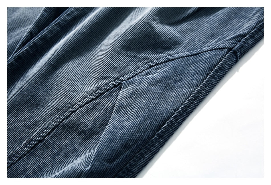 Close-up of blue-gray corduroy pants showing stitching and a folded fabric edge.