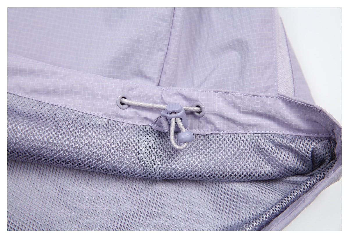Close-up of a pale lavender drawcord toggle above a section of matching mesh lining.