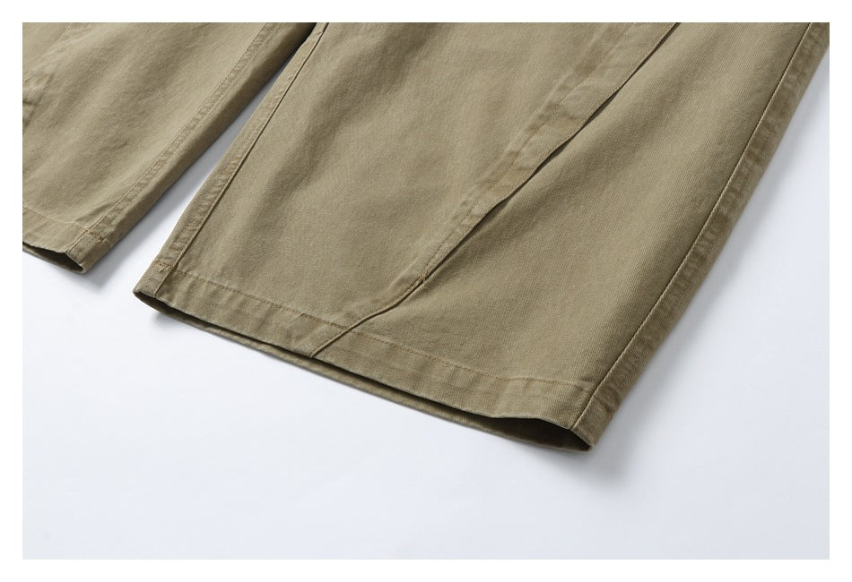 Close-up of the khaki trouser legs and stitched hems.