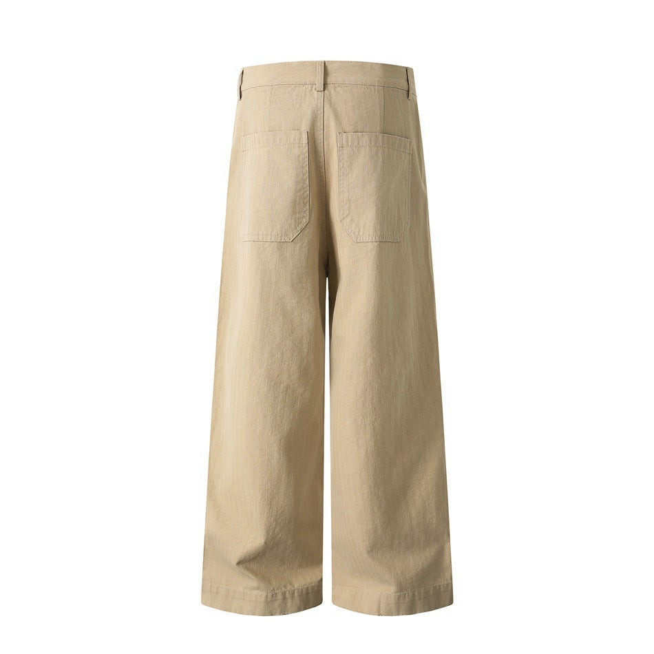 Back view of tan wide-leg trousers with two patch pockets and full-length hems.