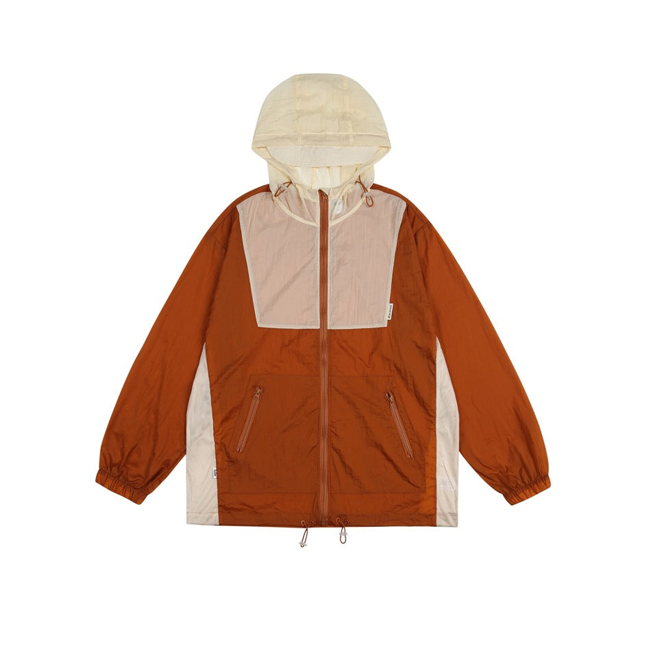 Orange-brown hooded zip jacket with cream hood, beige chest panel, cream side panels and zippered pockets, flat lay
