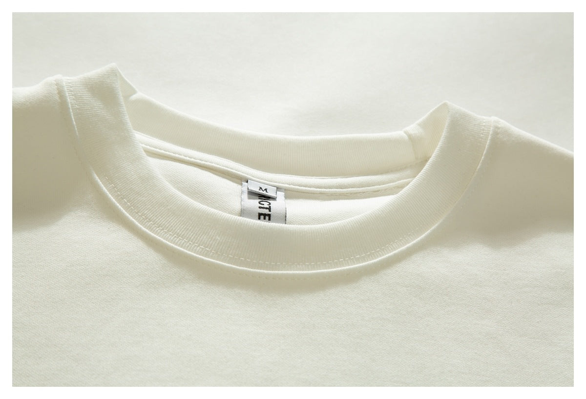 Close-up of the white T-shirt's ribbed crew neckline and inner neck label.