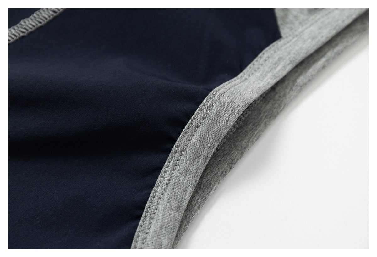 Close-up of the navy shirt's gray bound edge and parallel stitching.