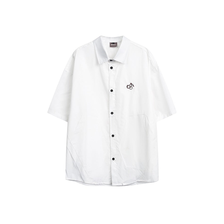 White short-sleeve button-up shirt with black buttons and a small cherry embroidery on the chest, front view